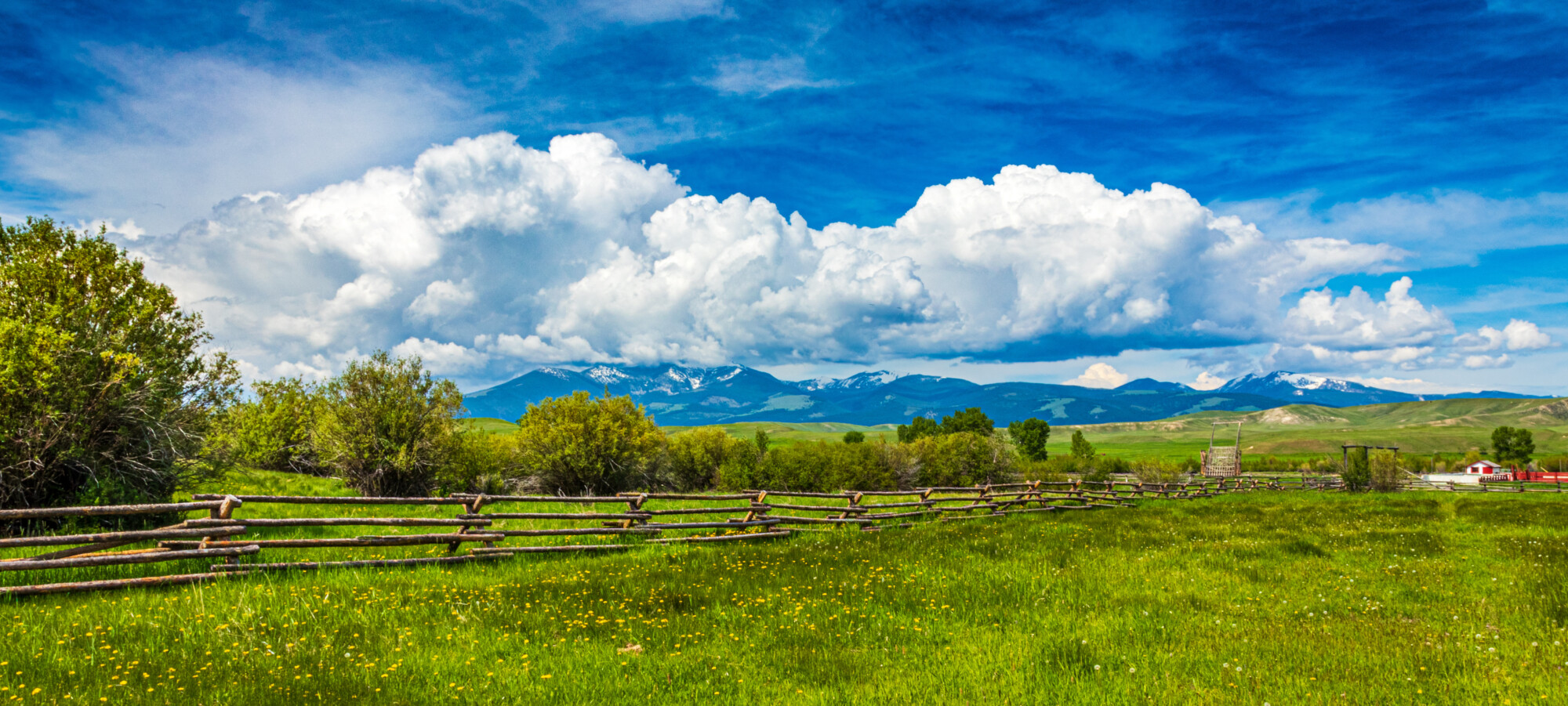 Montana Big Sky Landscape of a ranch fence with clouds and mount