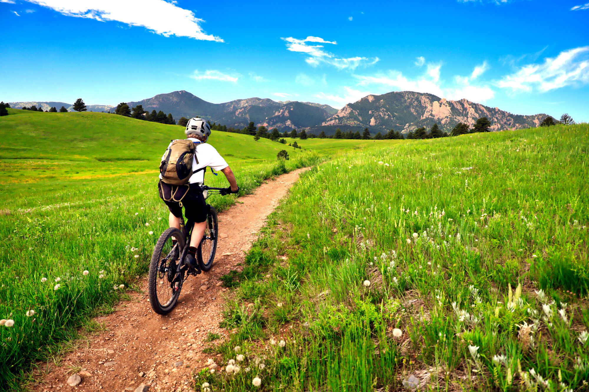 Mountain biker rides the Flatirons VIsta Trail near Boulder, Col