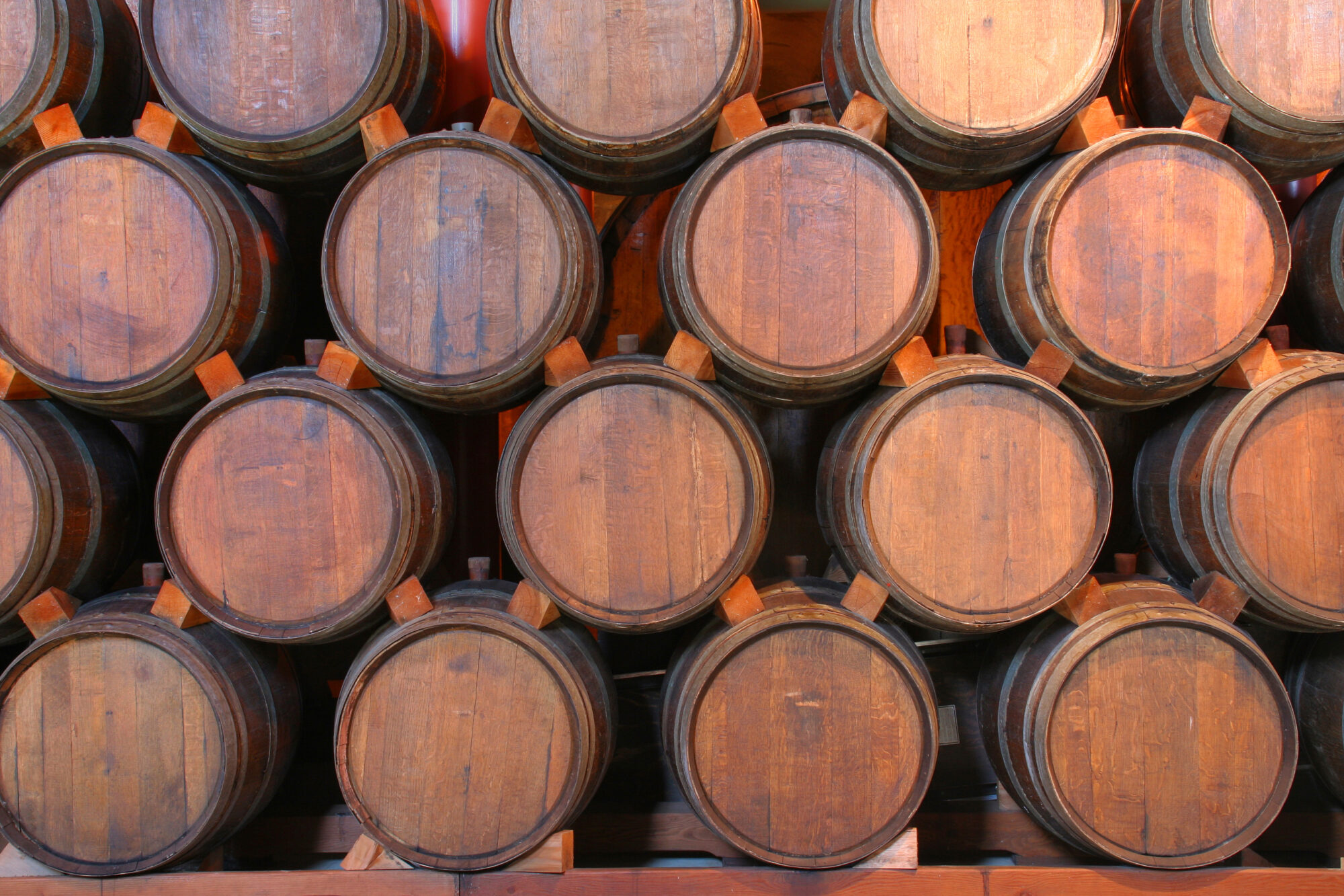 Oak Wine Barrels Stacked in Winery Cellar, Napa Valley, California